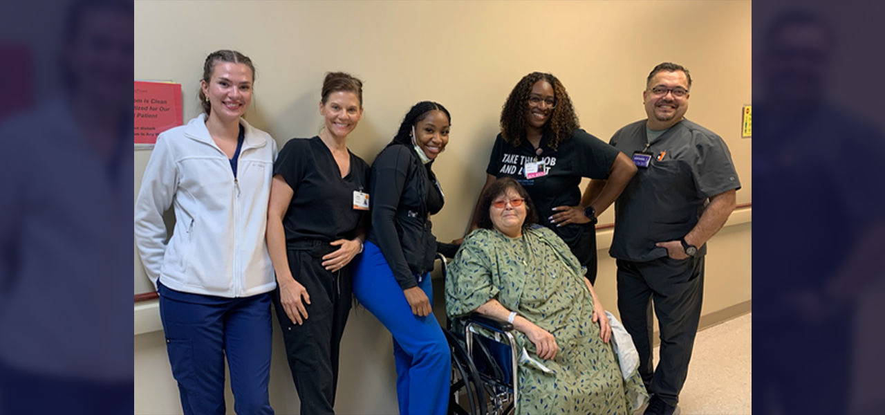 Happy patient leaving hospital with caregivers