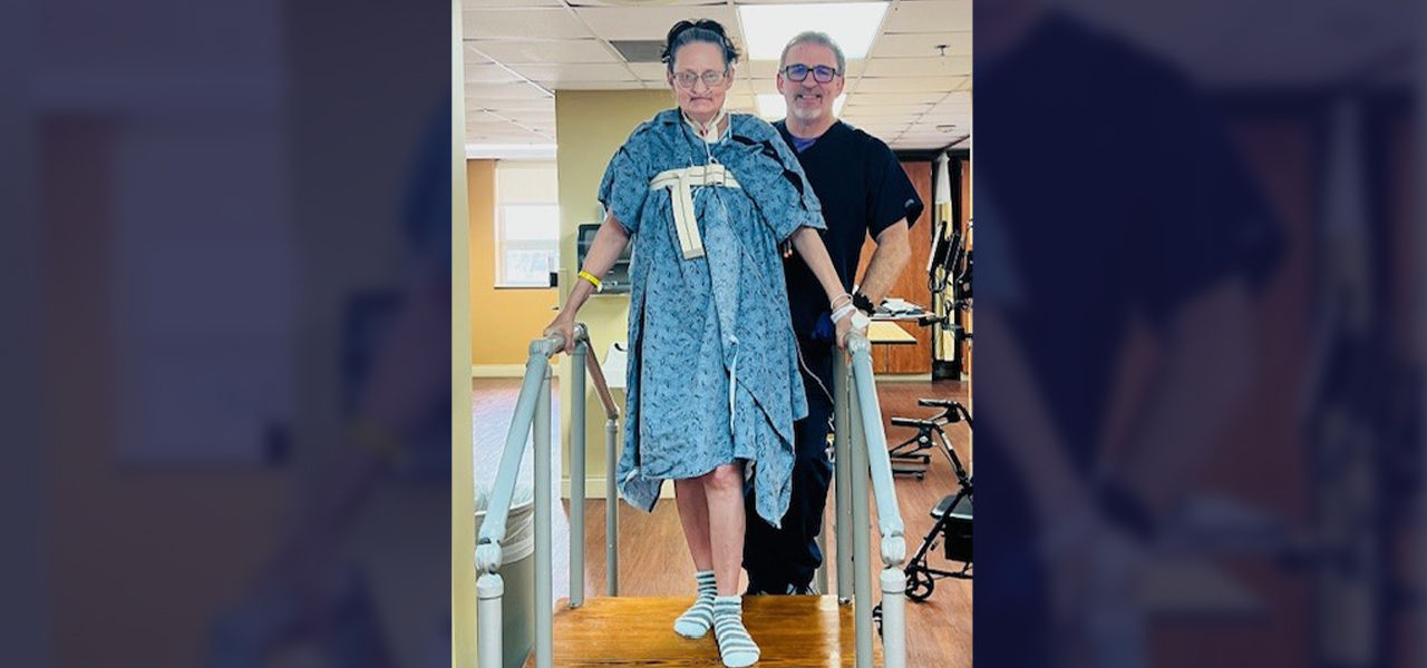 Happy patient with caregiver doing physical therapy