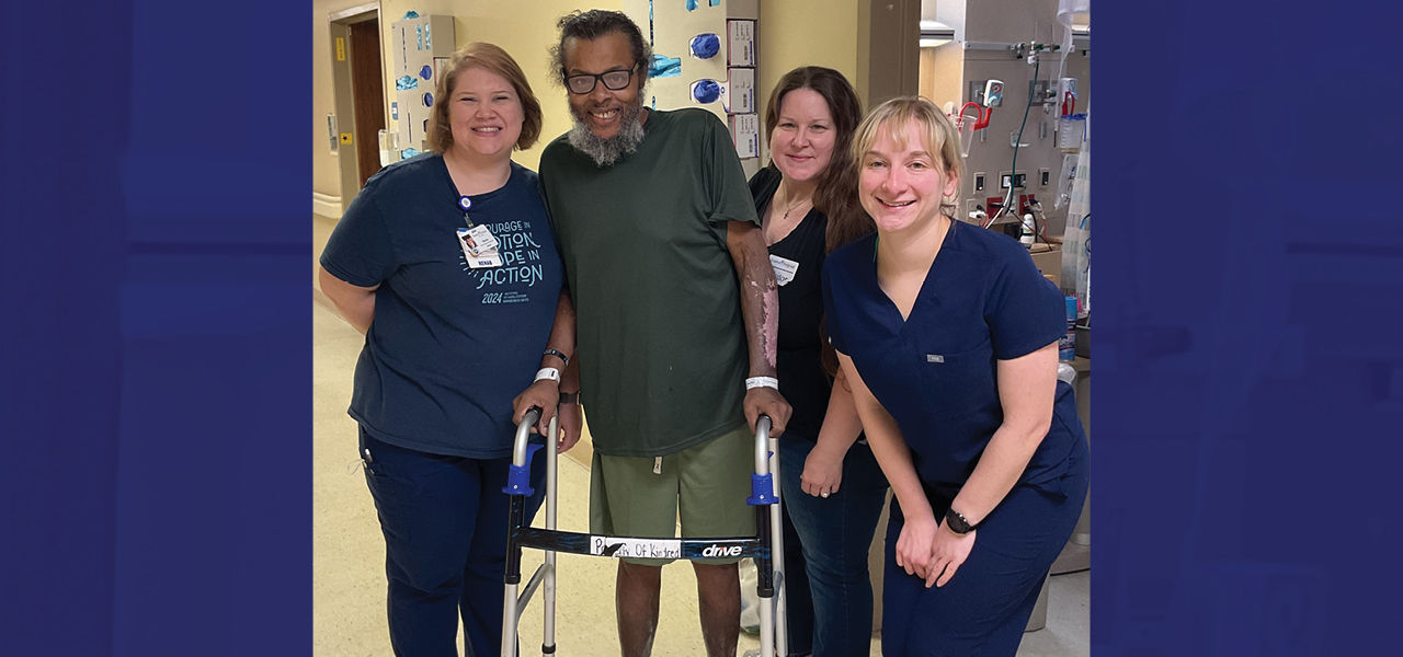 Kindred Hospital St Louis South patient Benedict stands with his care team and shares his story of recovery