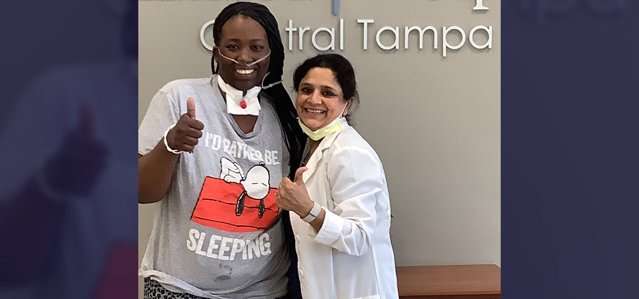 Happy patient leaving hospital with caregivers