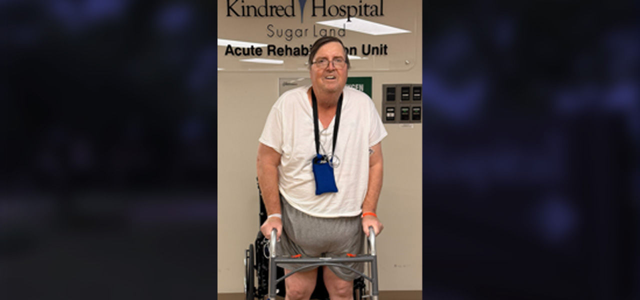 Kindred Hospital Sugar Land Patient Brian stands with a walker while sharing his story of successful recovery