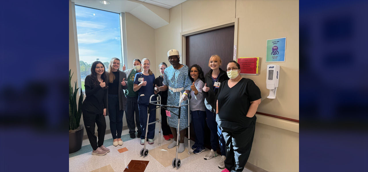 Kindred Hospital Clear Lake patient Charles stands with his care team