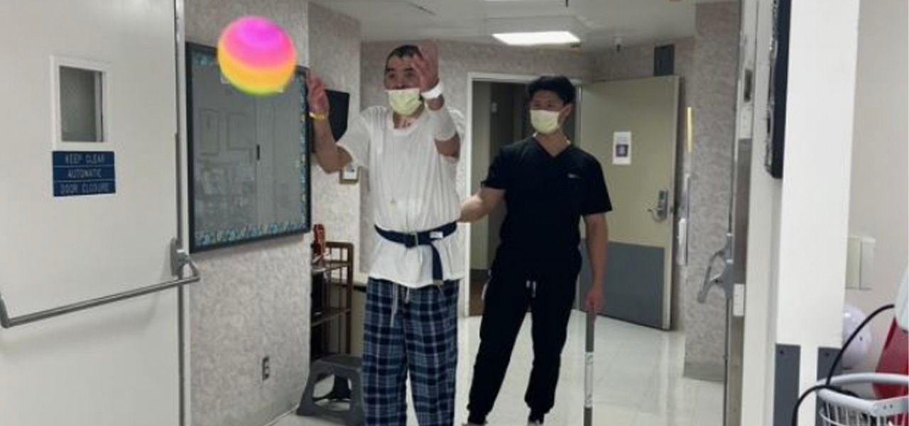 Kindred Hospital San Francisco Bay Area patient Christian works on his rehab games with his support team