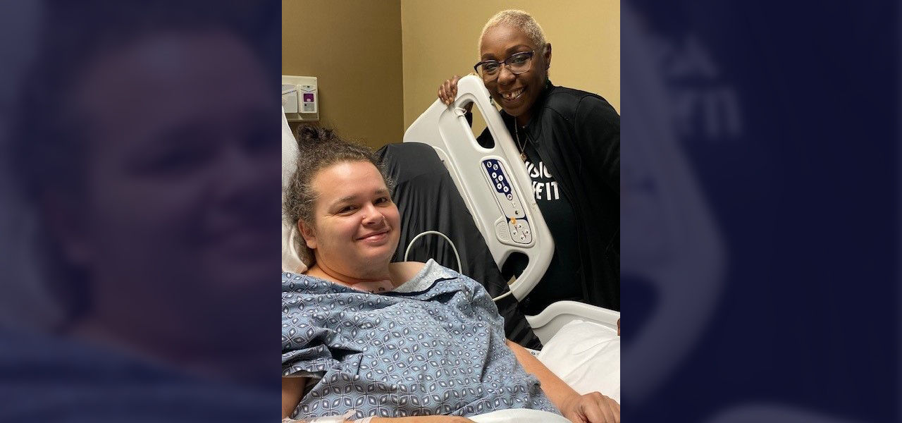 Happy patient in bed next to family member
