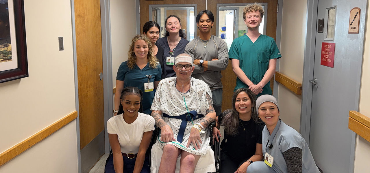 Kindred Hospital Aurora patient Darrell poses with his care team
