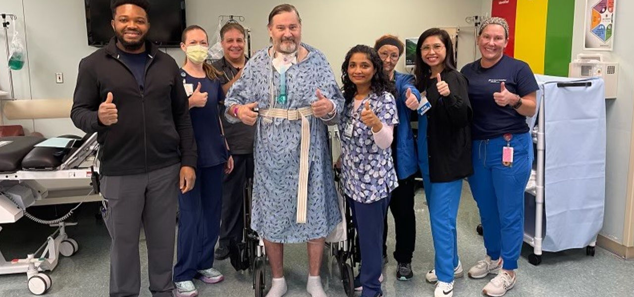 Happy patient leaving hospital with caregivers