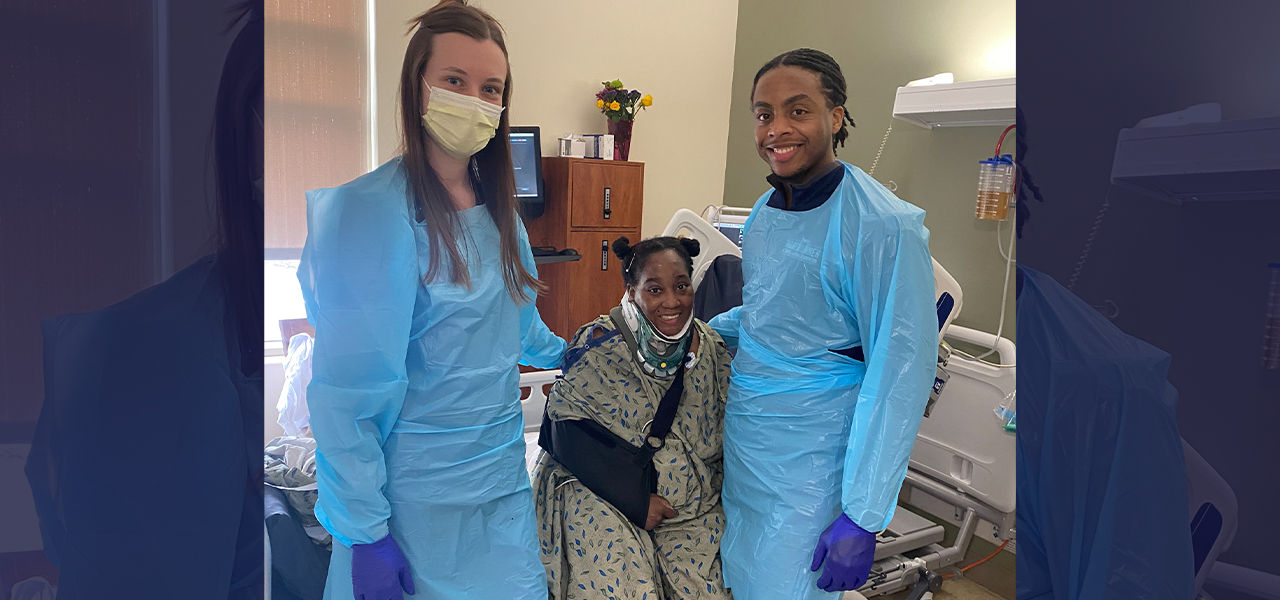 Happy patient leaving hospital with caregivers
