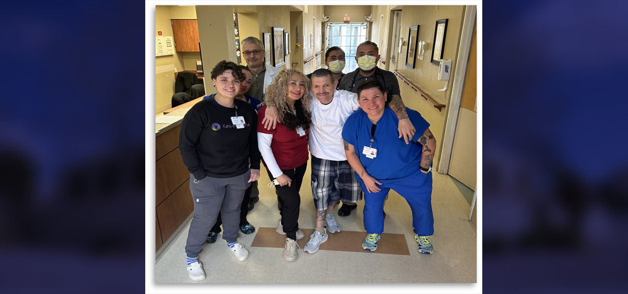 Kindred Hospital Albuquerque patient Eugene poses with his caregiver team