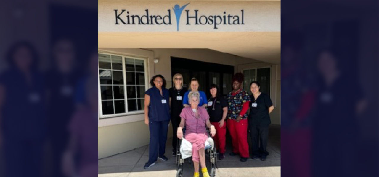 Happy patient leaving hospital with caregivers