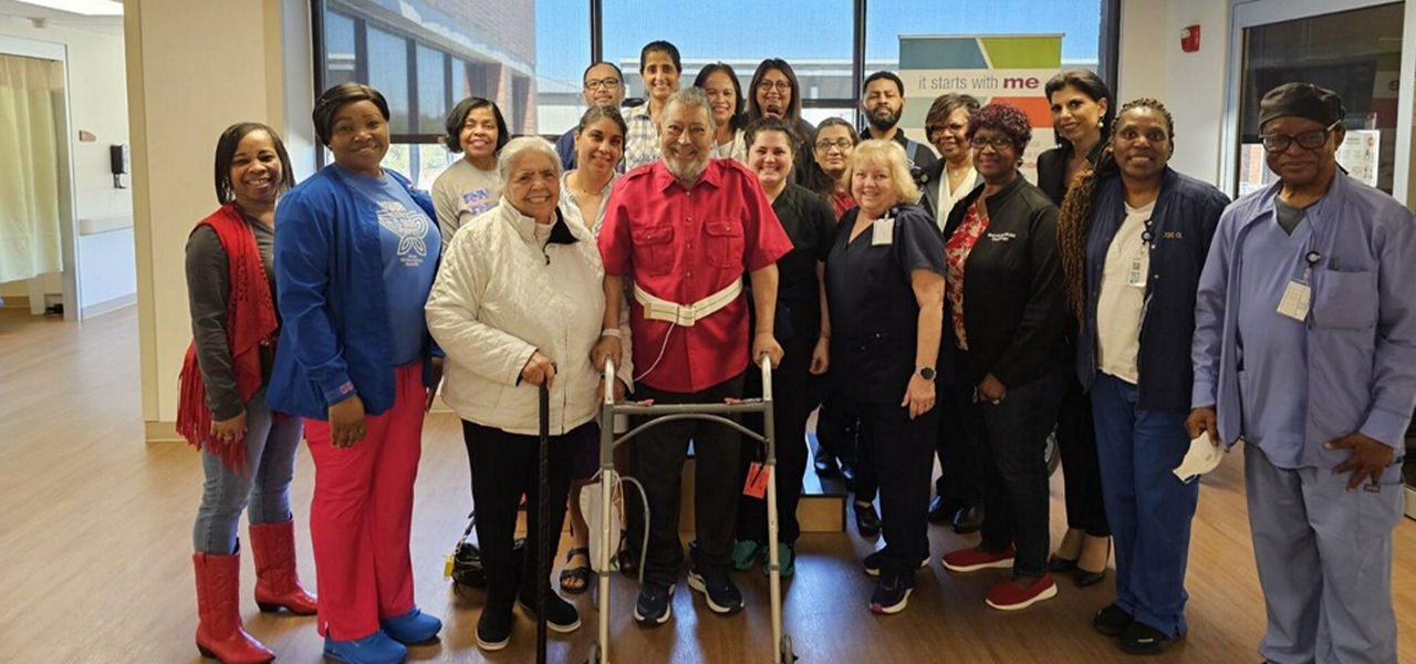 Happy patient leaving hospital with caregivers