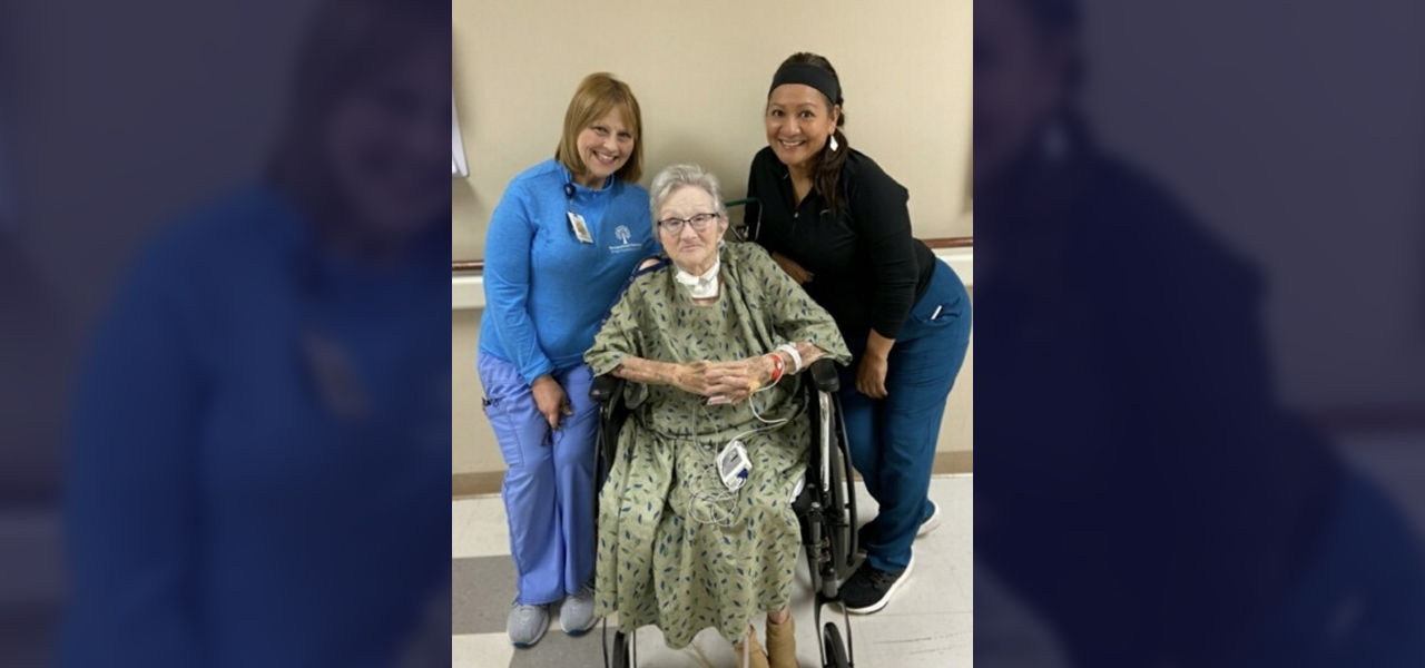Happy patient leaving hospital with caregivers