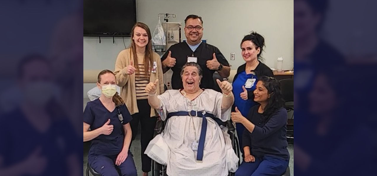 Happy patient leaving hospital with caregivers
