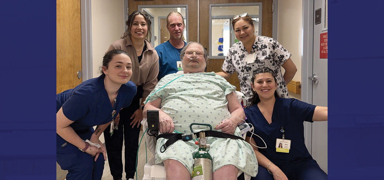 Kindred Hospital Aurora patient Gary poses with his care team