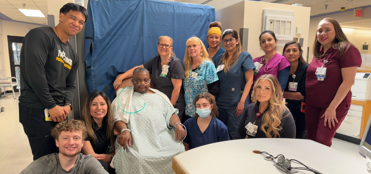 Kindred Hospital Aurora patient Gilbert poses with his care team