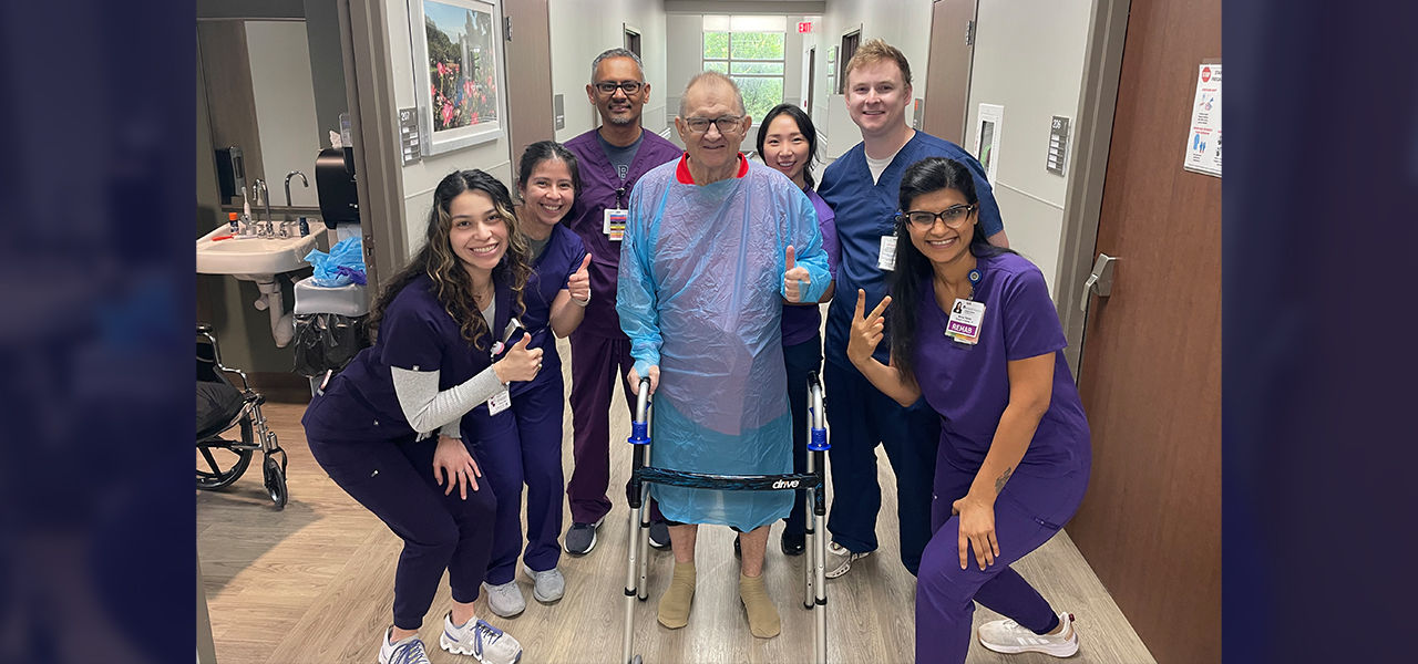 Happy patient leaving hospital with caregivers
