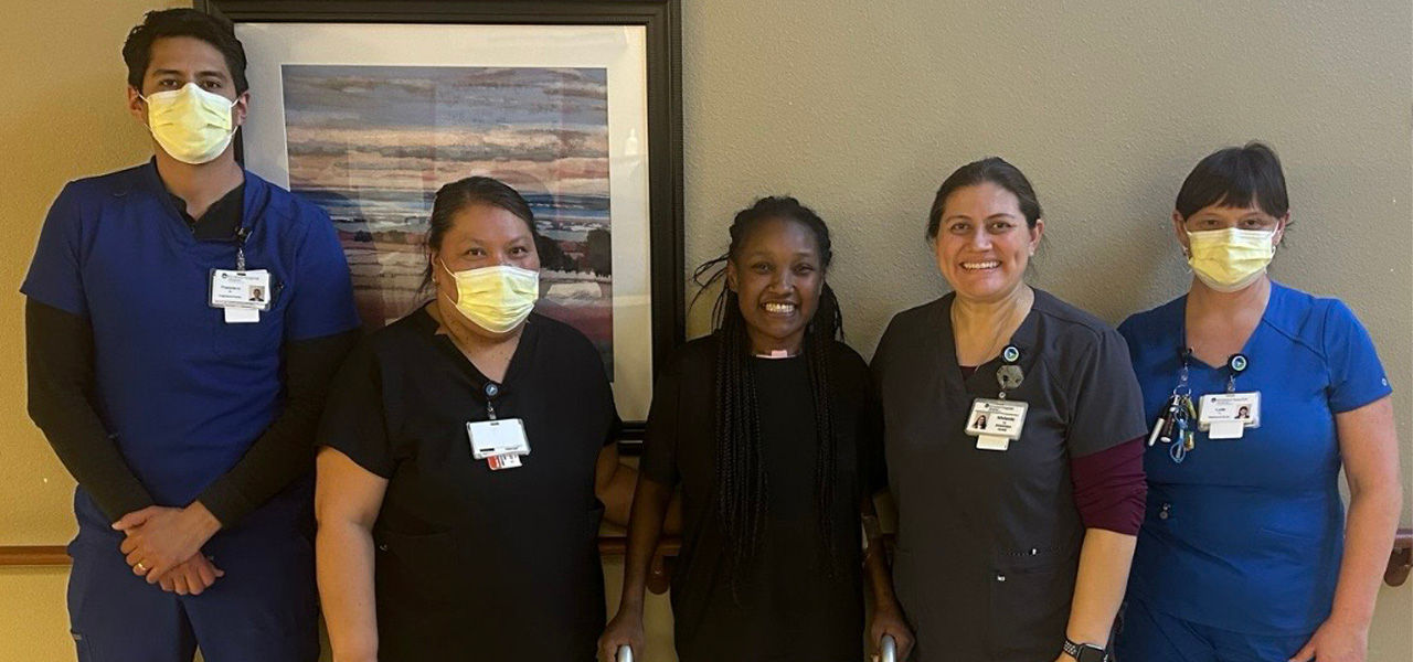 Kindred Hospital Albuquerque patient Jade stands with her support team that helped her recover from respiratory failure and other conditions. 