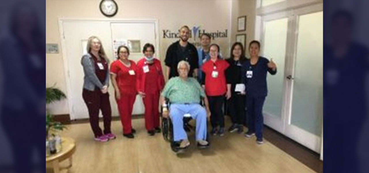 Happy patient in wheelchair with caregivers