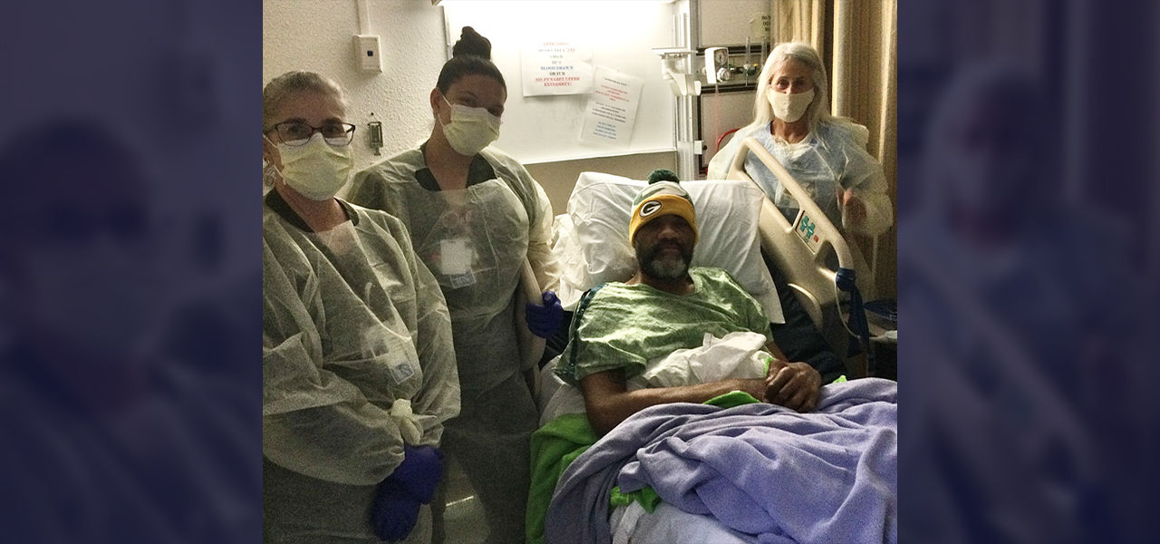 Happy patient leaving hospital with caregivers