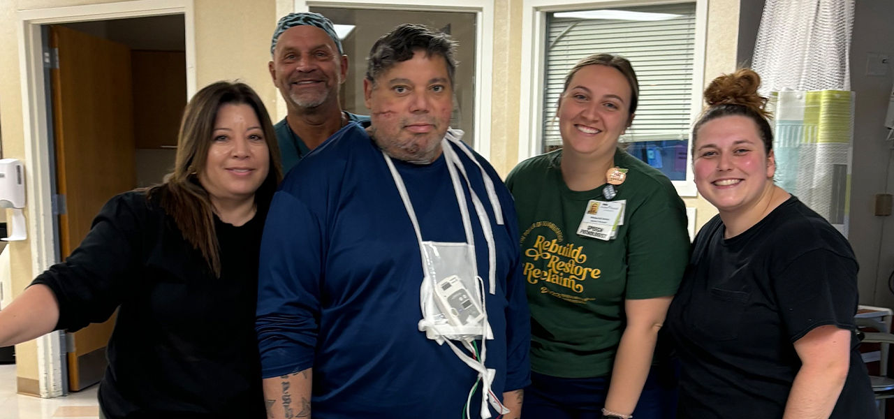 Happy patient leaving hospital with caregivers