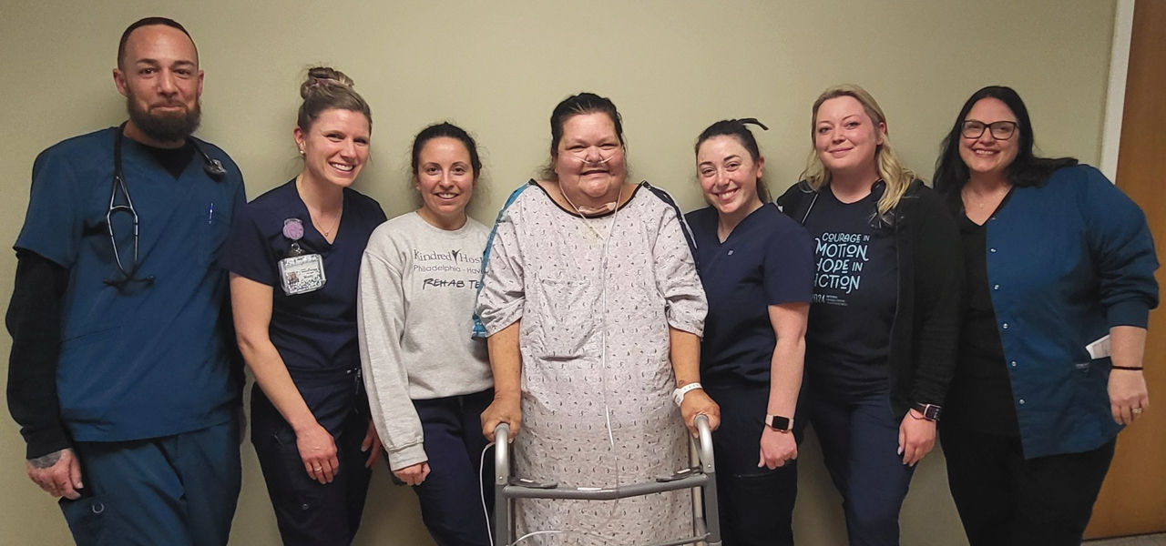 Kindred Hospital Havertown patient Kerry stands with her care team