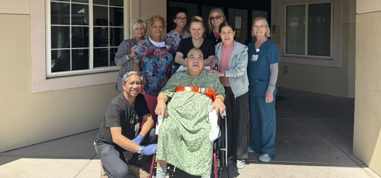 Happy patient leaving hospital with caregivers
