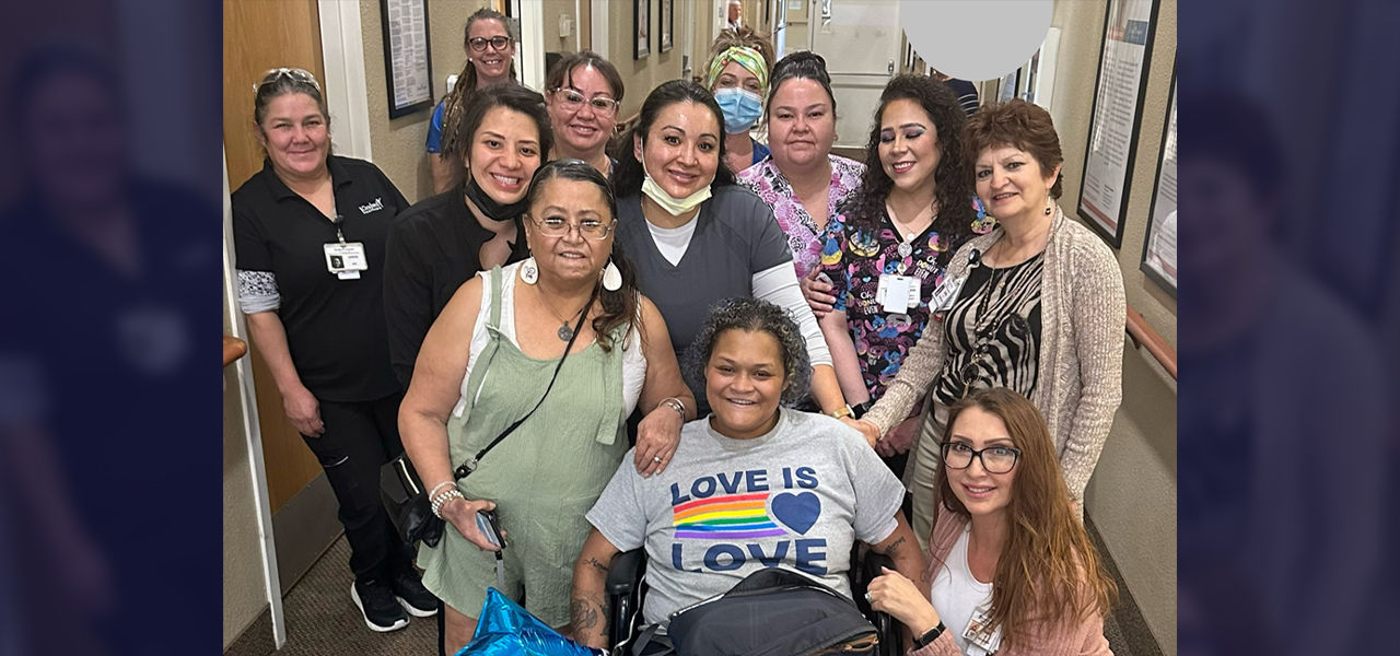 Happy patient leaving hospital with caregivers