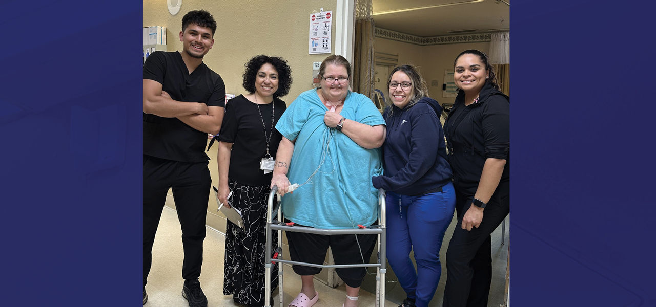 Kindred Hospital Albuquerque patient Lesa poses with her caregiver team