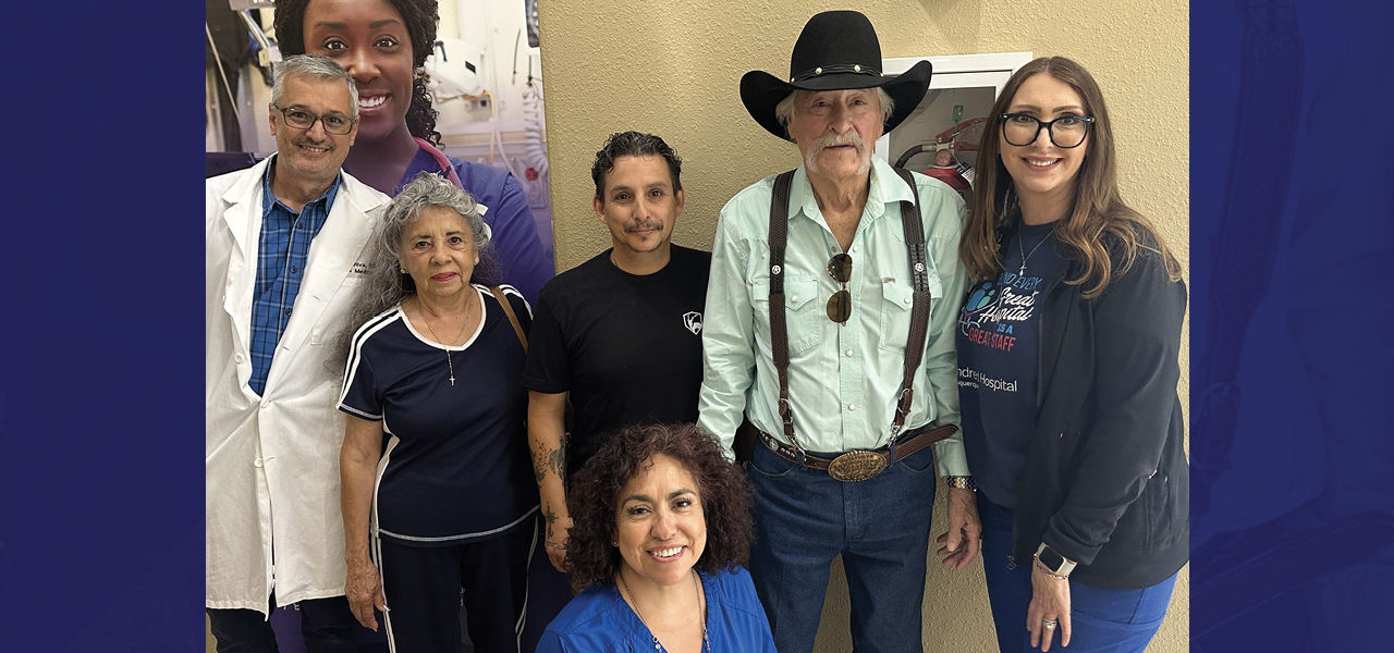 Kindred Hospital Albuquerque patient Lorenzo stands with his care team