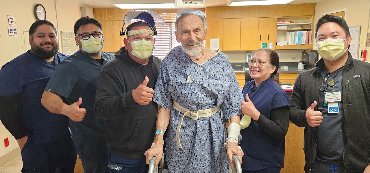 Kindred Hospital Santa Ana patient Lotha stands with his recovery team