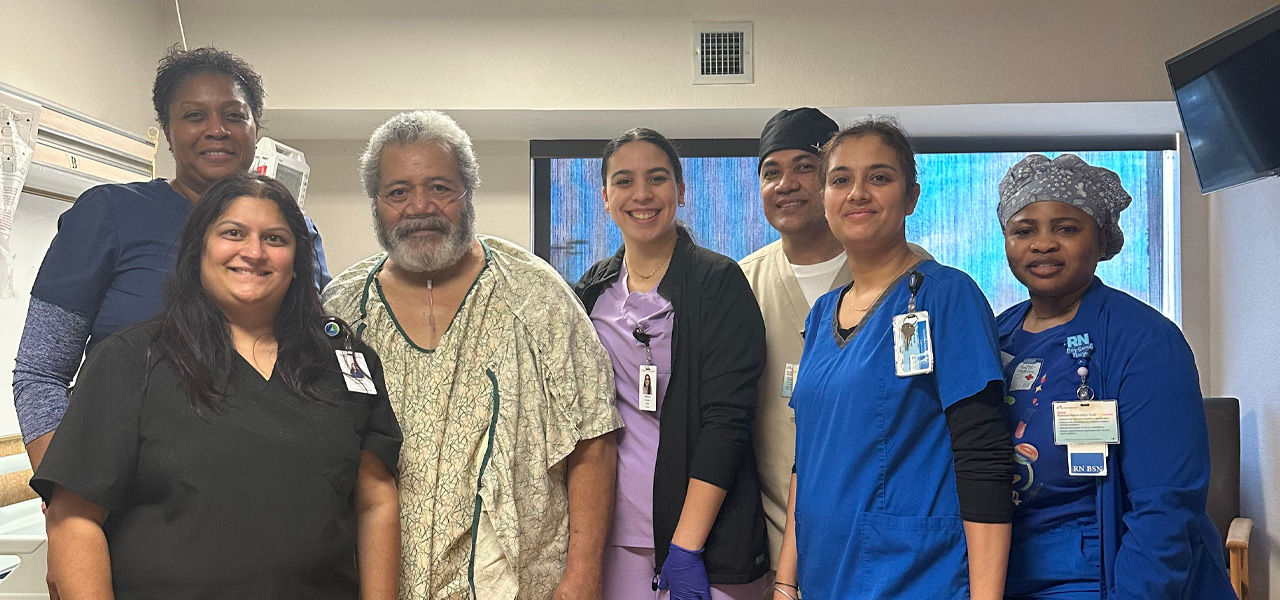 Kindred Hospital Tarrant County Arlington patient John stands with his support staff that helped him recover from respiratory issues