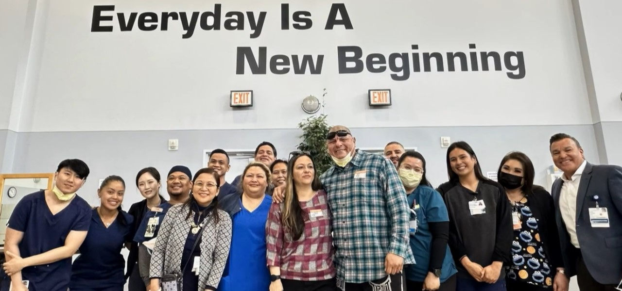 Actor/MMA fighter Mariano Mendoza (center in plaid shirt) and his wife, Dawn, visited the staff at Kindred Hospital Brea during the filming of “Fight For Life,” a documentary about his 2022 battle with COVID-19.