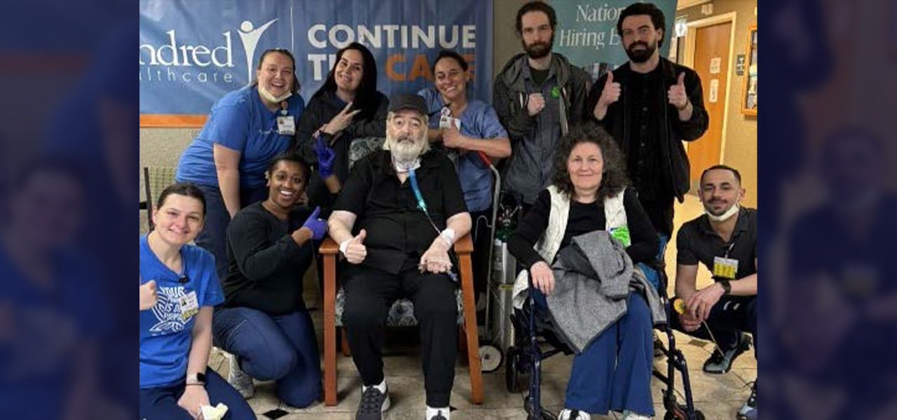 Happy patient leaving hospital with caregivers