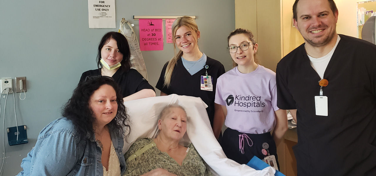 Kindred Hospital Northland patient Pam poses with her care team