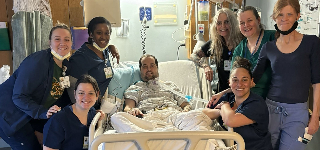 Happy patient leaving hospital with caregivers