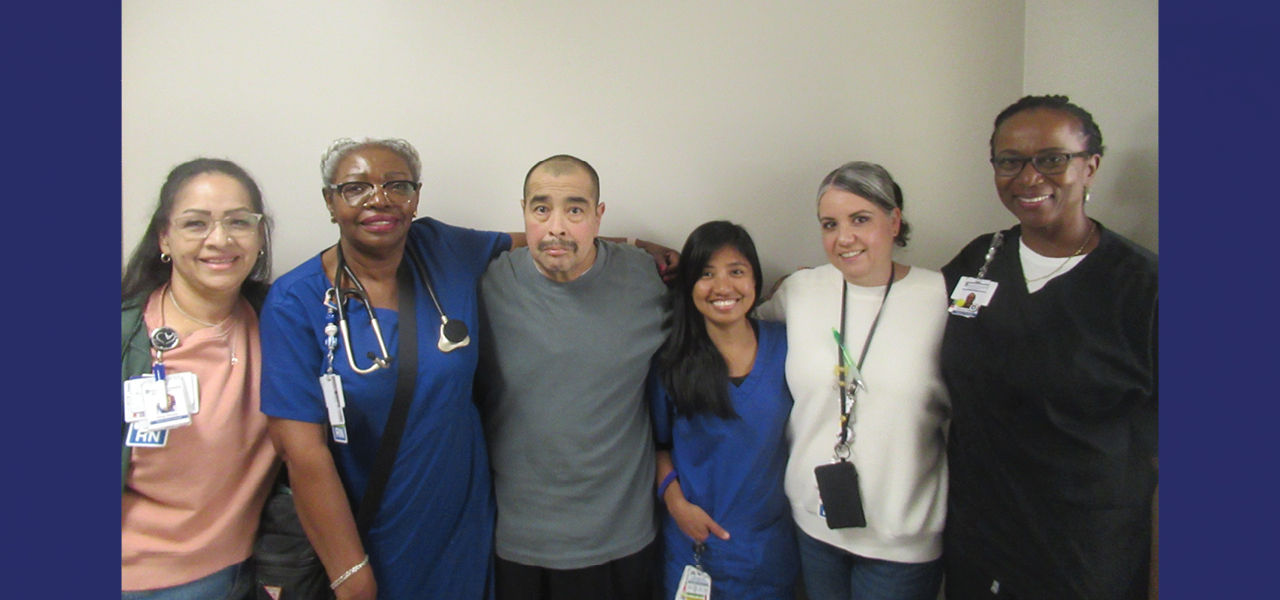 Kindred Hospital San Antonio Central patient Paul stands with his care team