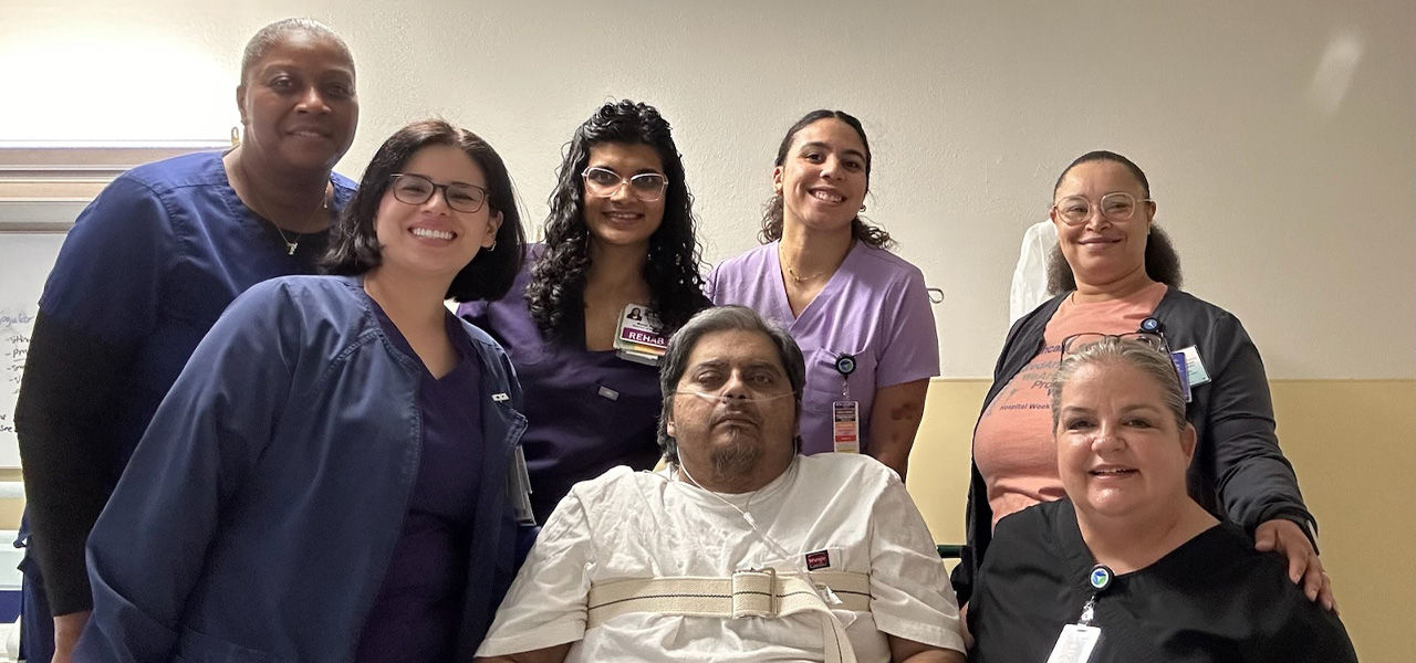 Kindred Hospital Tarrant County Arlington patient Rennie sits with his support staff that helped him recover from respiratory issues