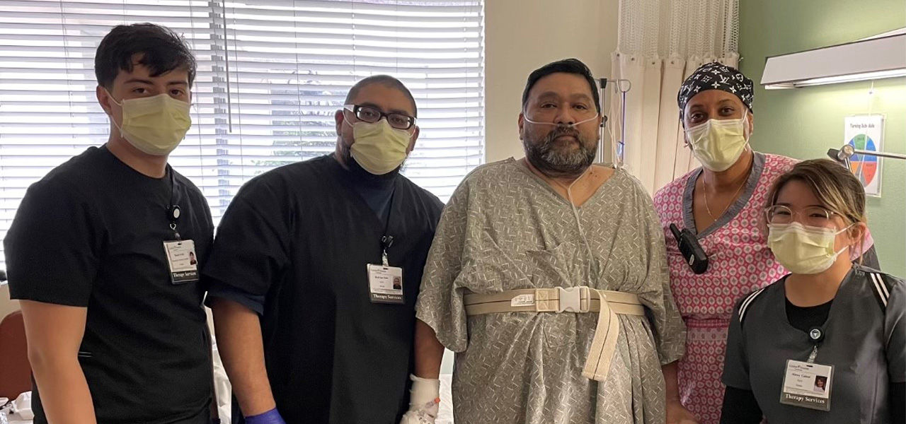 Kindred Hospital Paramount patient Ricardo stands with his care team