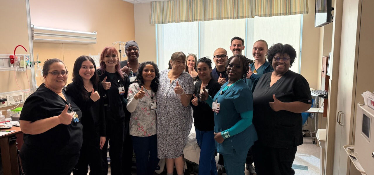 Kindred Hospital Clear Lake patient Susan stands with his care team