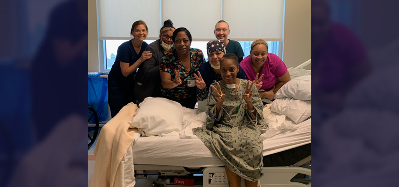 Happy patient leaving hospital with caregivers