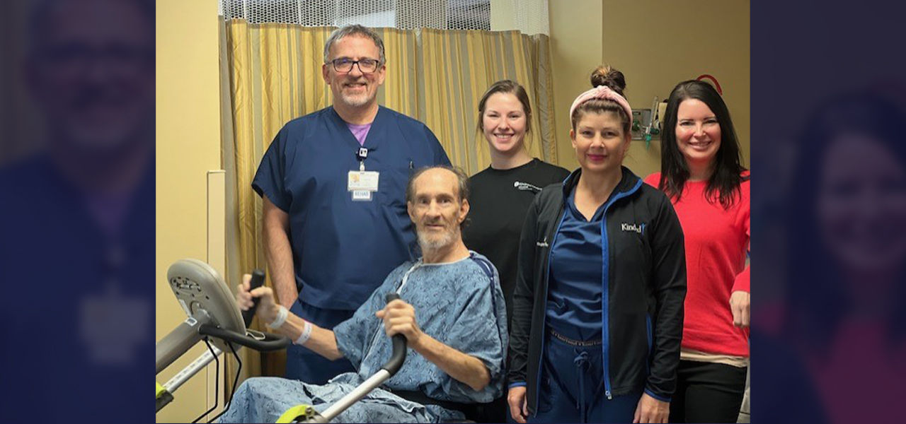 Happy patient with caregivers doing physical therapy