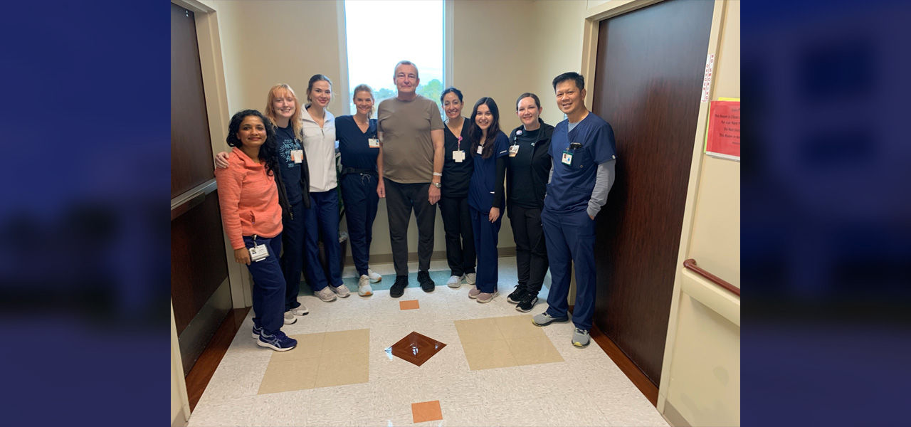 Kindred Hospital Clear Lake patient Uskov stands with his care team