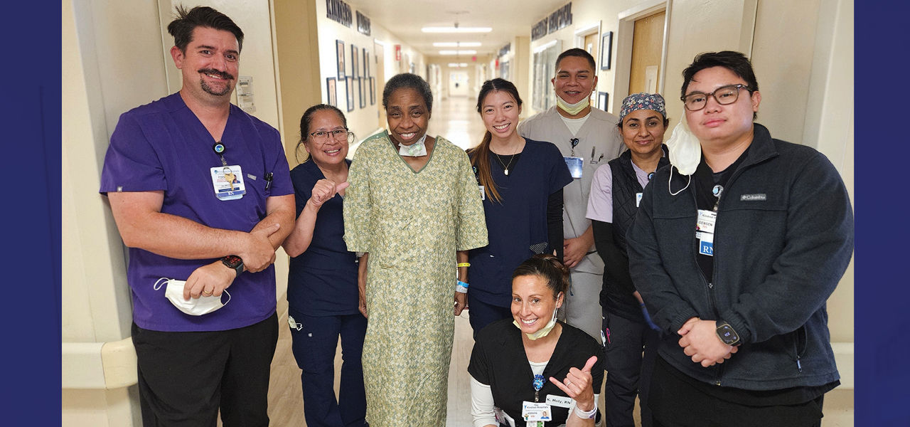 Kindred Hospital Santa Ana patient Velda stands with her recovery team