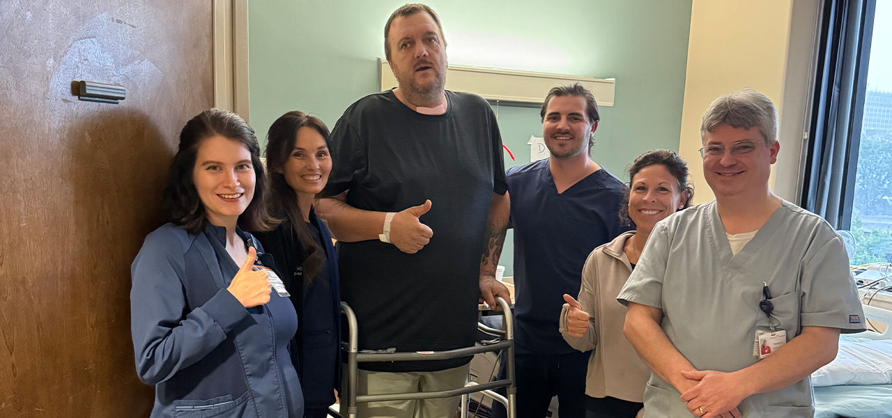 Kindred Hospital Louisville at Jewish patient William stands with his care team