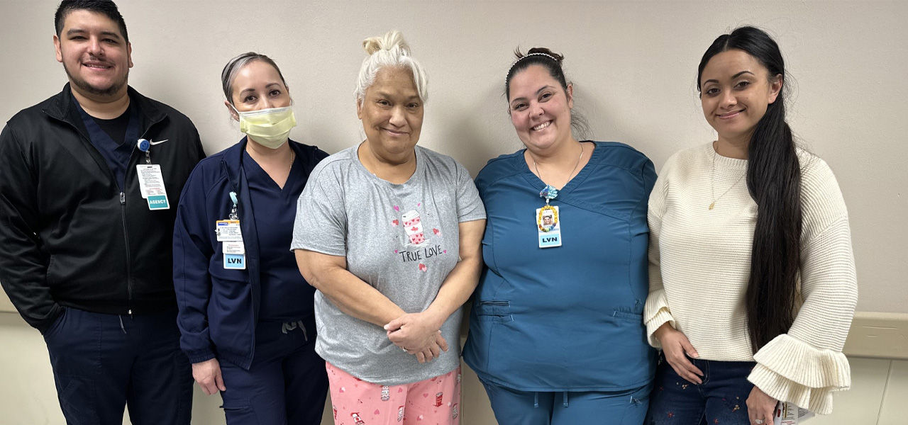 Kindred Hospital San Antonio patient Yvonne stands with her care team
